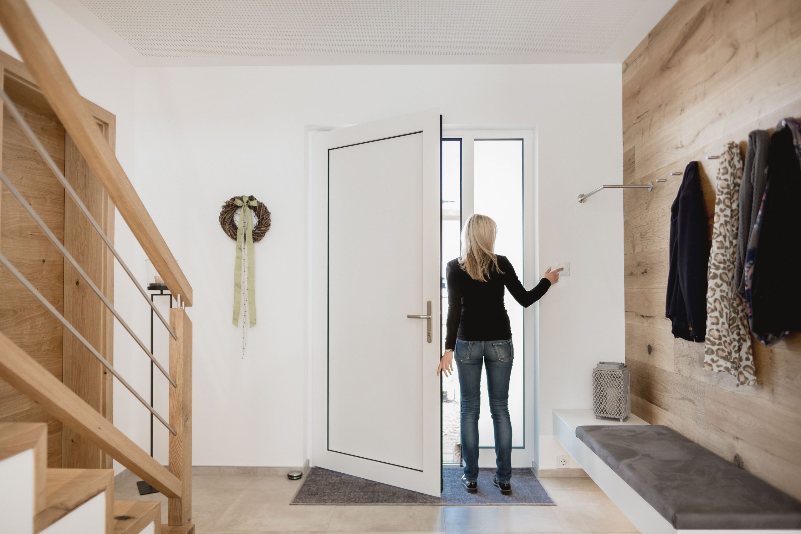 Woman leaving house turning off lights part of home automation